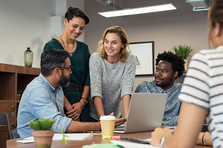 Multiethnic business people talking and smiling during meeting i